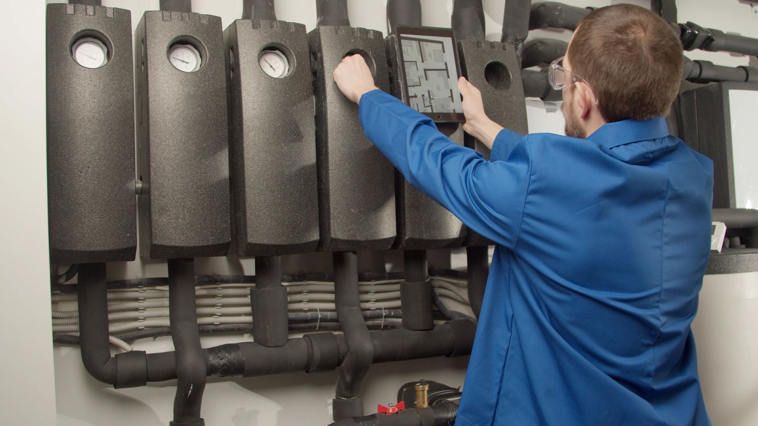 Technician checking gauges on a mechanical system