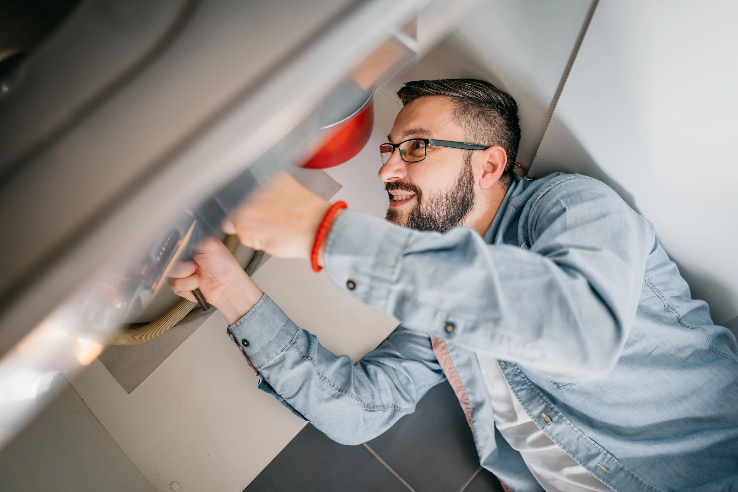Plumber working on residential plumbing repair