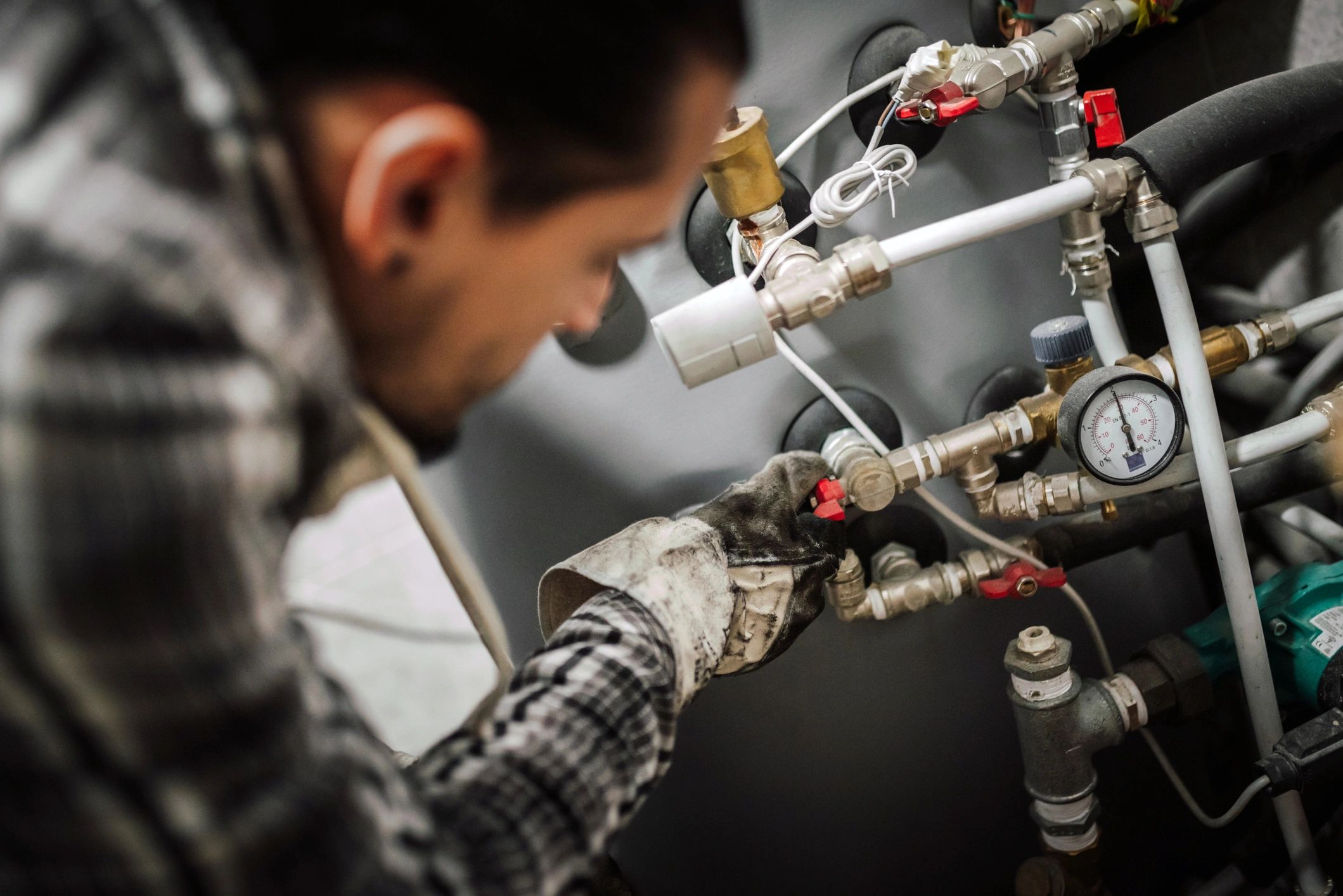 Technician repairing home plumbing pipes