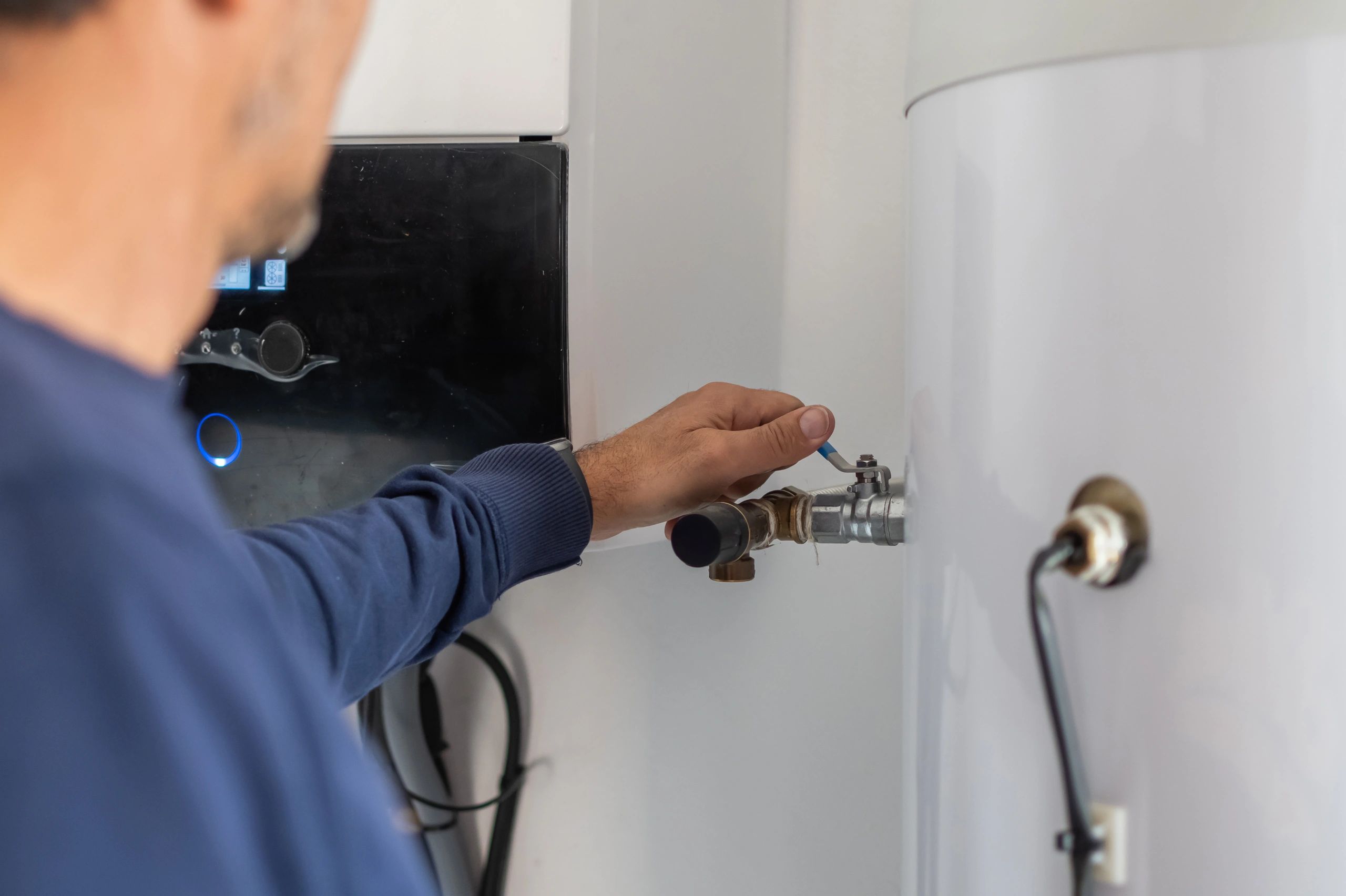 Home service technician working on plumbing equipment