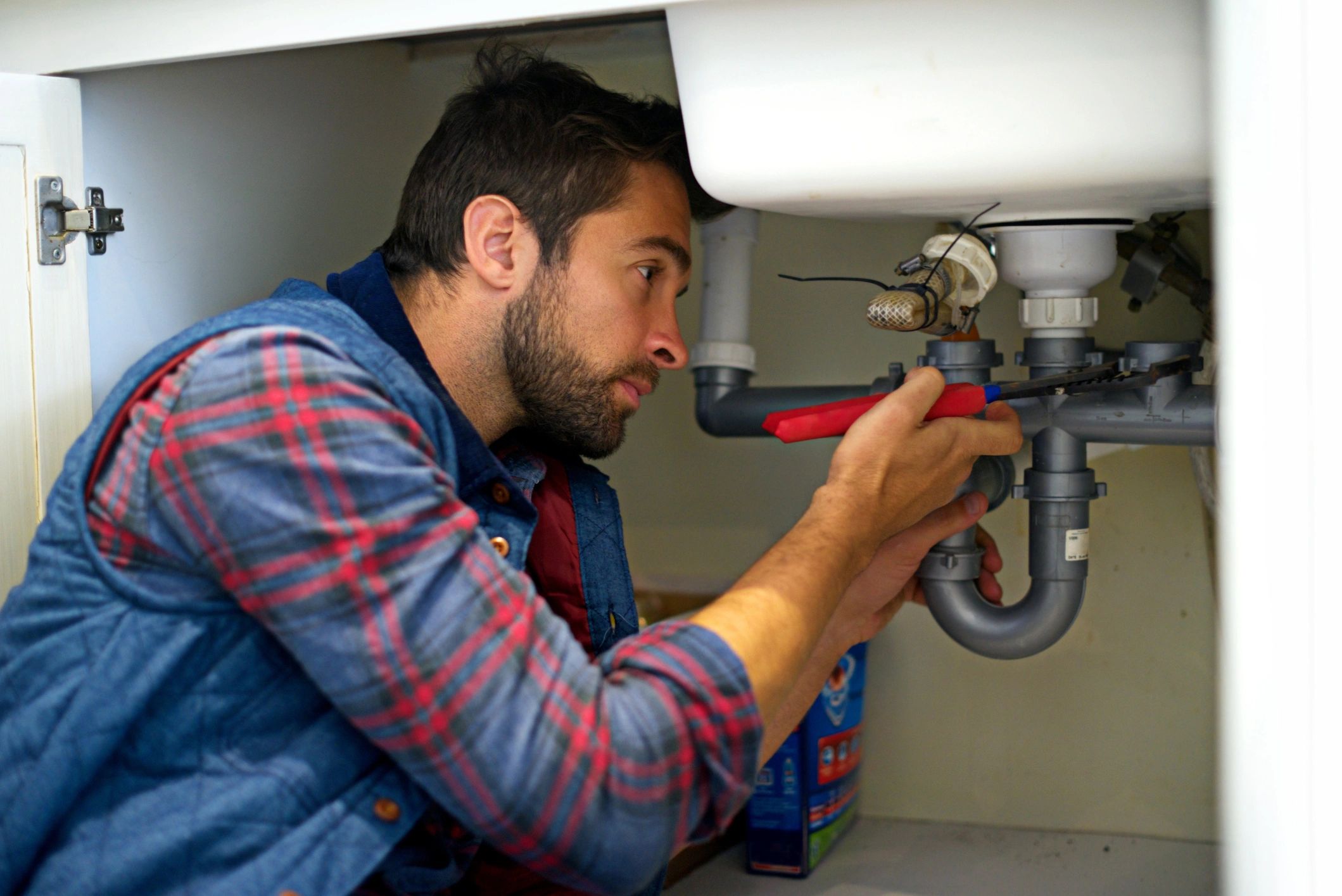 Plumber repairing a sink drain